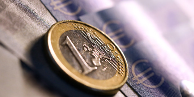 A one euro coin sits on 20 euro banknotes in this arranged photograph in London, U.K., on Tuesday, Sept. 19, 2017. The euro climbed 0.3 percent to $1.1986, the strongest in more than a week. Photographer: Chris Ratcliffe/Bloomberg via Getty Images