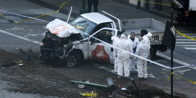 Investigators inspect a truck following a shooting incident in New York on October 31, 2017.
Several people were killed and numerous others injured in New York on Tuesday after a vehicle plowed into a pedestrian and bike path in Lower Manhattan, police said. 'The vehicle struck multiple people on the path,' police tweeted. 'The vehicle continued south striking another vehicle. The suspect exited the vehicle displaying imitation firearms & was shot by NYPD.' / AFP PHOTO / DON EMMERT (Photo credit should read DON EMMERT/AFP/Getty Images)