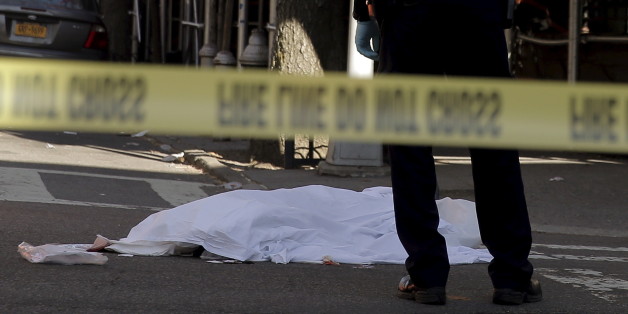 ATTENTION EDITORS - VISUAL COVERAGE OF SCENES OF DEATH AND INJURYA New York City Police (NYPD) officer stands over the covered body of a cyclist after being hit by a truck in the Park Slope section of Brooklyn, New York, U.S., April 20, 2016. REUTERS/Brendan McDermid