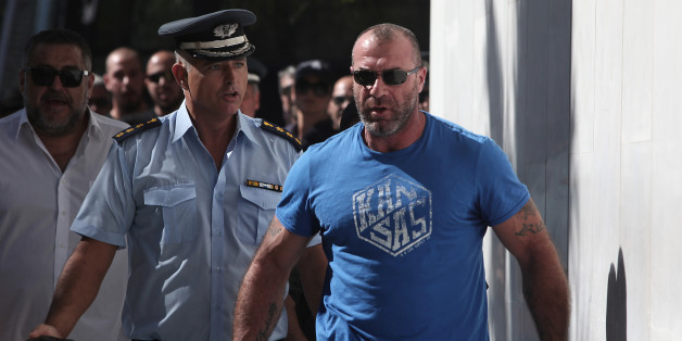 Michos Nikos, lawmaker of the extreme far-right Golden Dawn party, arrives at the police headquarters in Athens on September 28, 2013. Greek police on Saturday swooped on the neo-Nazi Golden Dawn party, arresting its leadership and hunting for dozens of members across the country in a crackdown sparked by the murder of a leftist musician. The arrests came a day after Golden Dawn threatened to pull its lawmakers out of parliament, a move that could spark a political crisis in the recession-hit co