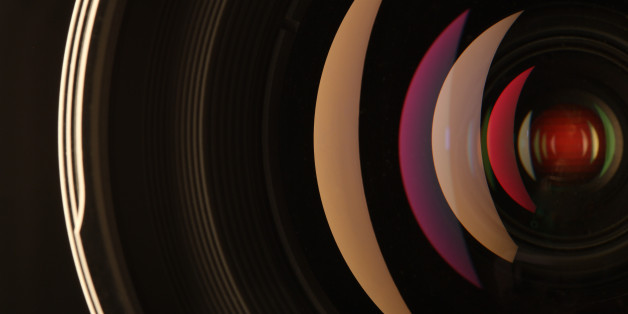 Camera lens reflections in glass