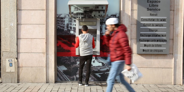 A man uses a cash machine in downtown Tunis, Tunisia, March 14, 2016. REUTERS/Zoubeir Souissi