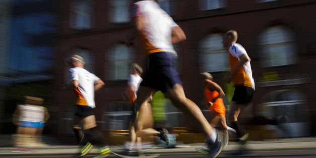Berlin, Germany - August 23: Amateur athletes jog during a city run across a street on August 23, 2015 in Berlin, Germany. (Photo by Thomas Trutschel/Photothek via Getty Images)