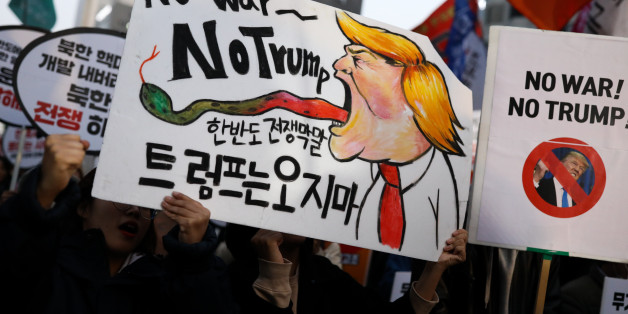 Demonstrators hold placards during a protest ahead of U.S. President Donald Trump's visit near the U.S. Embassy in Seoul, South Korea, on Saturday, Nov. 4, 2017. Trump said Friday that he will add a day to the end of his five-nation tour of Asia, saying he would now stay for 'the most important day' of a regional summit. Photographer: SeongJoon Cho/Bloomberg via Getty Images