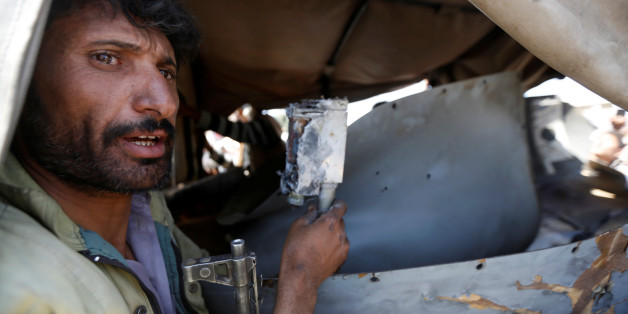 A Houthi fighter holds a part of a drone aircraft which the Houthi rebels said they have downed in Sanaa, Yemen October 1, 2017. REUTERS/Khaled Abdullah