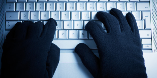 IT Crime consept Hacker works on laptop