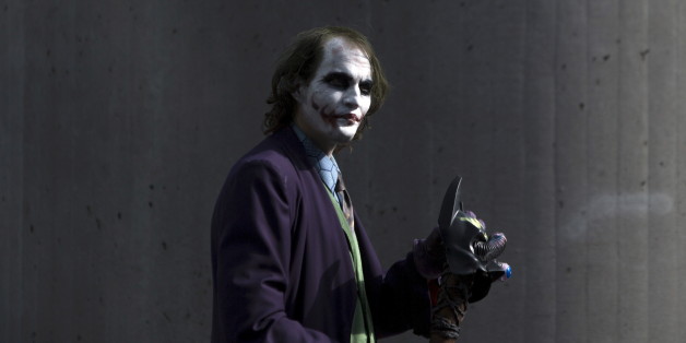 A man dressed as The Joker from "Batman" walks around the exterior on day two of New York Comic Con in Manhattan, New York, October 9, 2015. The event draws thousands of costumed fans, panels of pop culture luminaries and features a sprawling floor of vendors in a space equivalent to more than three football fields at the Jacob Javits Convention Center on Manhattan's West side. REUTERS/Andrew Kelly