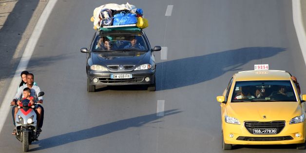 Tunisians return from the beach on the motorway from the port city of La Goulette to Tunis on the outskirts of the Tunisian capital on July 12, 2016. Run-down roads, reckless driving and poor vehicle maintenance are all being blamed for a spike in deadly traffic accidents in Tunisia that has safety experts worried. Road traffic deaths rose by nine percent in the first five months of this year compared with 2015, sparking calls for tougher measures to crack down on widespread traffic offences. /
