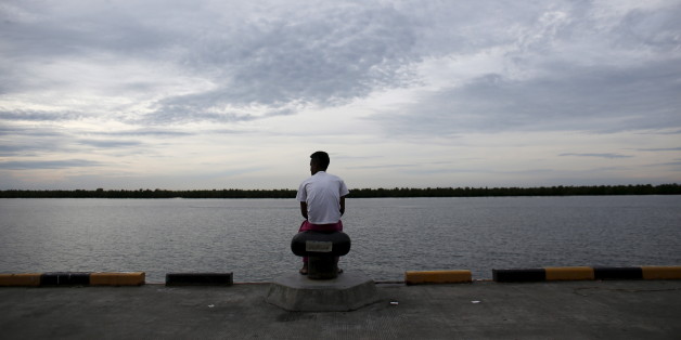 A Bangladeshi migrant who arrived recently by boat sits on a dock near a temporary shelter in Kuala Langsa, in Indonesia's Aceh Province May 25, 2015. Malaysia's police chief said on Monday that 139 graves believed to contain the remains of migrants were found near the country's border with Thailand, and that some graves contained more than one body. The graves were found at 28 suspected human trafficking camps located around 500 metres (550 yards) from the border in northern Malaysia, said Inspector General of Police Khalid Abu Bakar.
REUTERS/Darren Whiteside