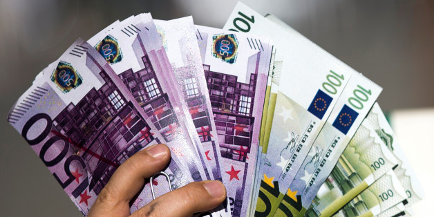 An activist shows fake banknotes during a demonstration outside the European Commission (EC) headquarters ahead of statements by the EC on the effectiveness of existing measures against tax evasion and money-laundering in light of the recent Panama Paper revelations, in Brussels, Belgium, April 12, 2016. REUTERS/Yves Herman