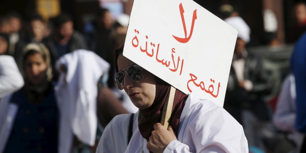 A demonstrator holds a sign as she takes part in a demonstration in the city of Casablanca, on February 25, 2016. Teachers protest through the streets against the two new decrees reducing their stipends and job security during a demonstration organised by trainee teachers. The sign reads, "Do not persecute teachers". REUTERS/Youssef Boudlal