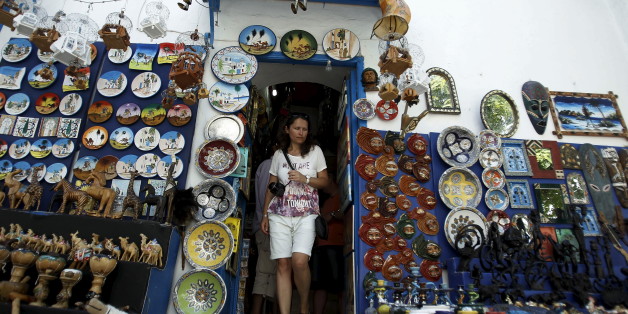 A tourist walks out of a traditional souvenir shop in Sidi Bou Said, near Tunis, Tunisia July 7, 2015. Tunisian President Beji Caid Essebsi declared a state of emergency on Saturday, saying the Islamist militant attack on a beach hotel that killed 38 foreigners had left the country "in a state of war". REUTERS/Zoubeir Souissi