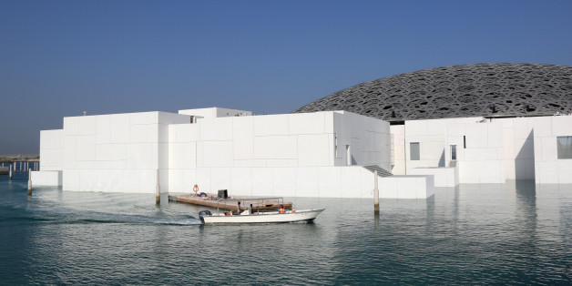 People ride a boat as the exterior of the Louvre Abu Dhabi is seen in Abu Dhabi, United Arab Emirates, November 6, 2017. Picture taken November 6, 2017. REUTERS/Satish Kumar