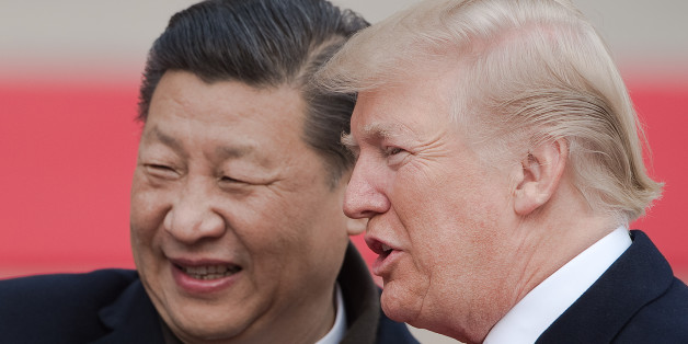 China's President Xi Jinping (L) and US President Donald Trump attend a welcome ceremony at the Great Hall of the People in Beijing on November 9, 2017. / AFP PHOTO / NICOLAS ASFOURI (Photo credit should read NICOLAS ASFOURI/AFP/Getty Images)