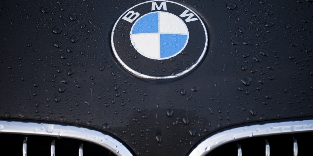 'Padua, Italy - July 6, 2011: Circle shape BMW logo and part of the front grill on a black car covered with dew drops. BMW (Bayerische Motoren Werke) is a German automobile, motorcycle and engine manufacturing company founded in 1916.'