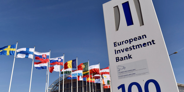 Flags are seen behind the logo of the European Investment Bank is pictured in the city of Luxembourg, Luxembourg, March 25, 2017. Reuters/Eric Vidal
