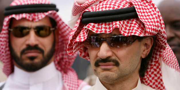 Saudi Prince Al-Walid bin Talal talks to reporters at a food distribution point in Shaba, 10 km from the northeast town of Garrisa, Kenya June 6, 2006. REUTERS/Stephen Morrison/Pool (KENYA)