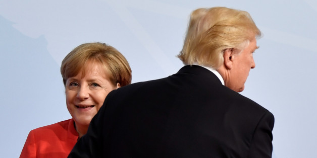 German Chancellor Angela Merkel greets U.S. President Donald Trump at the beginning of the G20 summit in Hamburg, Germany, July 7, 2017. REUTERS/John MACDOUGALL,POOL