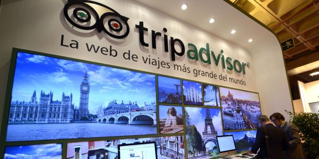 Visitors watch documents at the stand of TripAdvisor during the International Tourism Trade Fair (FITUR) in Madrid on January 22, 2014. Delegations will attend the edition of the FITUR fair to promote each country's tourist industry. AFP PHOTO/ GERARD JULIEN (Photo credit should read GERARD JULIEN/AFP/Getty Images)