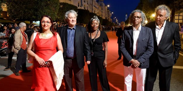 Carthage Film Festival's president of jury, Palestinian director Michel Khleifi (2nd L), arrives for the opening ceremony of the 28th edition on November 4, 2017 in Tunis. / AFP PHOTO / FETHI BELAID (Photo credit should read FETHI BELAID/AFP/Getty Images)