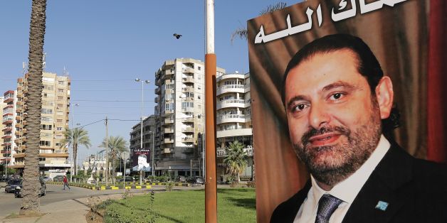 A poster of Lebanese Prime Minister Saad Hariri, who resigned last week in a televised speech airing from the Saudi capital Riyadh, hangs on the side of a roundabout in the northern Lebanese port city of Tripoli on November 10, 2017, with a caption above reading in Arabic: 'God protect you.'Hariri's announced resignation sparked concerns of a political crisis in Lebanon as tensions between Saudi Arabia and Iran escalated. / AFP PHOTO / JOSEPH EID (Photo credit should read JOSEPH EID/AFP/G