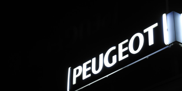 Nijmegen, The Netherlands - November 17, 2011: White illuminated Mercedes-Benz logo outside a dealership at night.