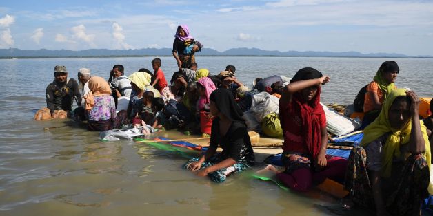 Rohingya Muslim refugees sail a makeshift raft made from jerrycans and bamboo across the Naf River into Bangladesh at Sabrang, Teknaf district on November 11, 2017.More than 600,000 Rohingya have fled to Bangladesh since late August carrying accounts of murder, rape and arson at the hands of Myanmar's powerful army during a military crackdown dubbed as 'ethnic cleansing' by the UN. / AFP PHOTO / Dibyangshu SARKAR (Photo credit should read DIBYANGSHU SARKAR/AFP/Getty Images)