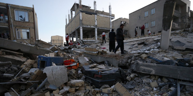 People including rescue personnel conduct search and rescue work following a 7.3-magnitude earthquake at Sarpol-e Zahab in Iran's Kermanshah province on November 13, 2017.
At least 164 people were killed and 1,600 more injured when a 7.3-magnitude earthquake shook the mountainous Iran-Iraq border triggering landslides that were hindering rescue efforts, officials said. / AFP PHOTO / ISNA / POURIA PAKIZEH (Photo credit should read POURIA PAKIZEH/AFP/Getty Images)