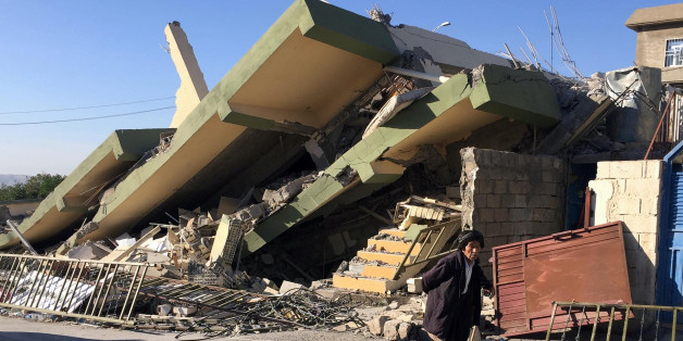 A man walks past a damaged building following an earthquake in Darbandikhan in Sulaimaniya Governorate, Iraq, November 13, 2017. REUTERS/Ako Rasheed