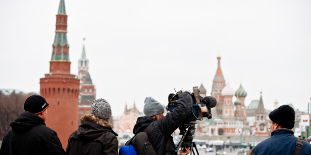 Moscow, Russia - December 10, 2011: TV Reporters installing their camera in front of Red Square on the bridge. Crowds of people walking on Bridge from Red Square and famous St.Basil Cathedral to Bolotnaya square - place of Opposition Demonstration against fraudulent Parliament Elections. Protesters walking from Red Square to Bolotnaya Square. This Demonstration was organised by opposition parties. Thousands gather at Bolotnaya Square (from 50.000 to 100.000) to protest against election fraud. More than 50.000 police officers were in the center of Moscow this day. This was the biggest protest event for last 20 years in Russia.