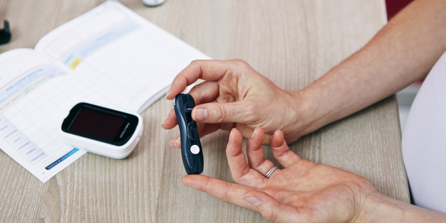 Pregnant woman checking her blood glucose level. (Photo by: BSIP/UIG via Getty Images)