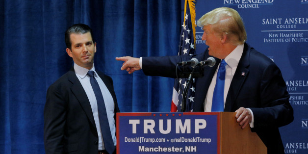 FILE PHOTO: Then U.S. Republican presidential candidate Donald Trump (R) welcomes his son Donald Trump Jr. to the stage at one of the New England Council's "Politics and Eggs' breakfasts in Manchester, New Hampshire November 11, 2015. REUTERS/Brian Snyder/Files