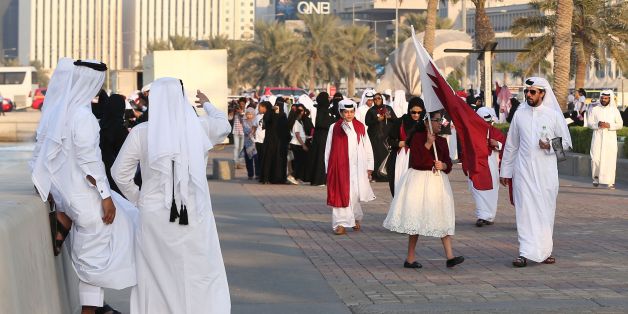 Qataris take to the streets of Doha to welcome back the Emir upon his returned from his first trip abroad during the ongoing Gulf diplomatic crisis on September 24, 2017. / AFP PHOTO / KARIM JAAFAR (Photo credit should read KARIM JAAFAR/AFP/Getty Images)