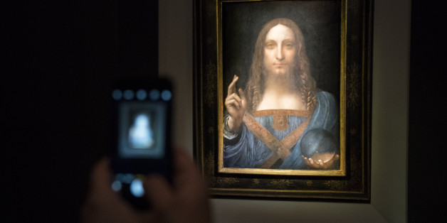 NEW YORK, NY - NOVEMBER 15: A visitor takes a photo of the painting 'Salvator Mundi' by Leonardo da Vinci at Christie's New York Auction House, November 15, 2017 in New York City. The coveted painting is set to be auctioned off on Wednesday night and has been guaranteed to sell for over $100 million.(Drew Angerer/Getty Images)