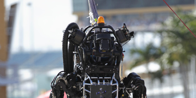 Boston Dynamics' Atlas, a high-mobility, humanoid robot designed to negotiate rough terrain, takes on an irregular surface in this terrain negotiation exercise in Homestead, Florida December 20, 2013.The south Florida city is hosting an international Robotics Challenge Trials this weekend, organized by the U.S. Defense Advanced Research Projects Agency (DARPA). The competition, for the creation of robots that can respond to natural and man-made disasters, was created following the 2011 Fukushima