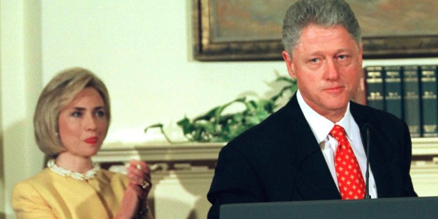 President Clinton says he is going back to work while first lady Hillary Rodham Clinton applauds during a White House event unveiling new child care proposals, January 26. Clinton delivered his strongest denial yet that he had had sexual relations with former White House intern Monica-Lewinsky.