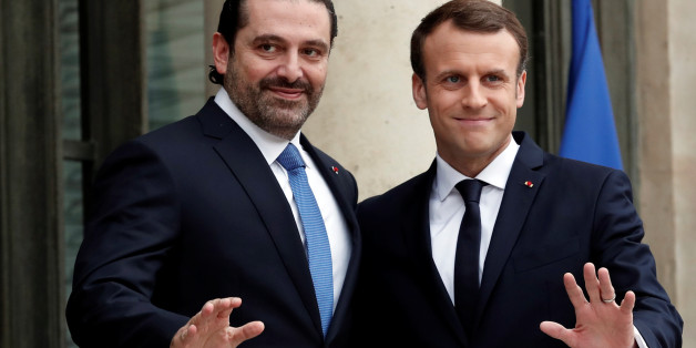 French President Emmanuel Macron and Saad al-Hariri, who announced his resignation as Lebanon's prime minister while on a visit to Saudi Arabia, react on the steps of the Elysee Palace in Paris, France, November 18, 2017. REUTERS/Benoit Tessier