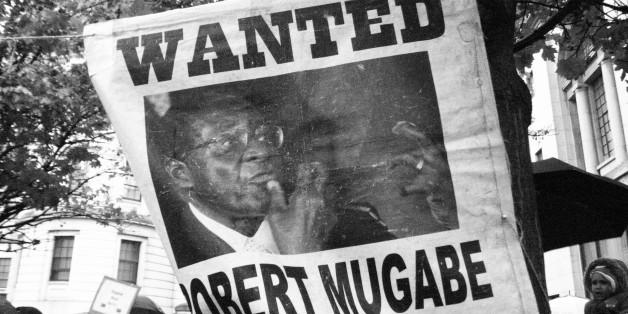 Protesters demonstrate outside the Embassy of Zimbabwe in London to call on the leader of the country Robert Mugabe to resign on November 18, 2017 in London, England. 93-year-old Mr Mugabe has been under house arrest following a military takeover in Zimbabwe with generals urging him to resign. (Photo by Jay Shaw Baker/NurPhoto via Getty Images)