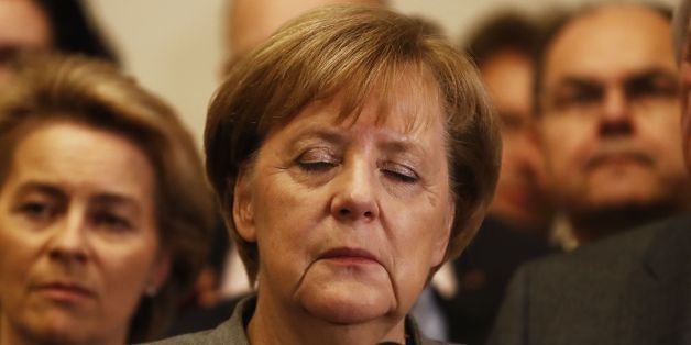 German Chancellor and leader of the Christian Democratic Union (CDU) party, Angela Merkel (C), closes her eyes after exploratory talks on forming a new government broke down on November 19, 2017 in Berlin.Tough talks to form Germany's next government stretched into overtime, putting Chancellor Angela Merkel's political future in the balance since failure to produce a deal could force snap elections. / AFP PHOTO / Odd ANDERSEN (Photo credit should read ODD ANDERSEN/AFP/Getty Images)