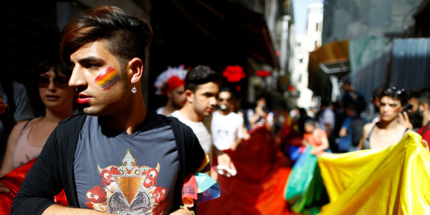 LGBT rights activists hold a rainbow flag during a transgender pride parade which was banned by the governorship, in central Istanbul, Turkey, June 19, 2016. REUTERS/Osman Orsal