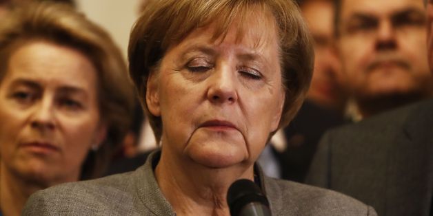 German Chancellor and leader of the Christian Democratic Union (CDU) party, Angela Merkel (C), closes her eyes after exploratory talks on forming a new government broke down on November 19, 2017 in Berlin.Tough talks to form Germany's next government stretched into overtime, putting Chancellor Angela Merkel's political future in the balance since failure to produce a deal could force snap elections. / AFP PHOTO / Odd ANDERSEN (Photo credit should read ODD ANDERSEN/AFP/Getty Images)