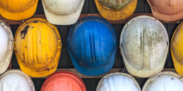 Old and worn colorful construction helmets