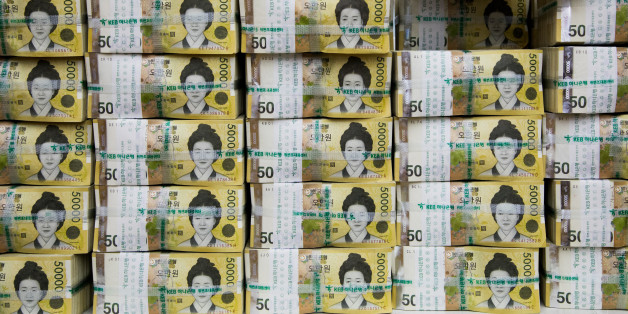 An employee arranges genuine bundles of South Korean 50,000 won banknotes for a photograph at the Counterfeit Notes Response Center of KEB Hana Bank in Seoul, South Korea, on Monday, Aug. 14, 2017. The won advanced for the first day in four as top U.S. national security officials sought to damp down talk of am imminent war with North Korea following days of heightened rhetoric. Photographer: SeongJoon Cho/Bloomberg via Getty Images