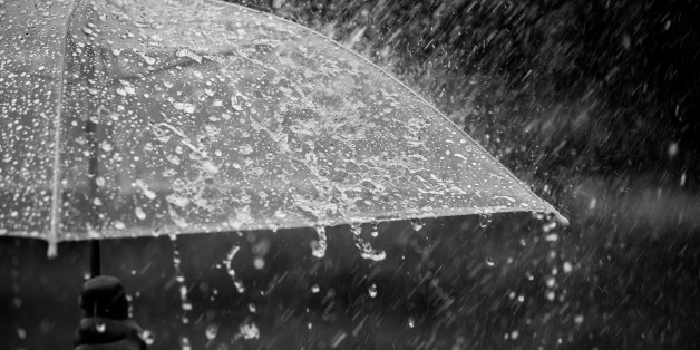 Splashing water on umbrella in the rain in black and white color tone