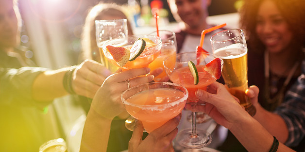Shot of a group of people toasting with their drinks at a nightclub