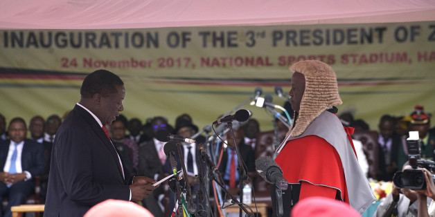 TOPSHOT - Emmerson Mnangagwa (L) is sworn in as the new Zimbabwe's president in Harare, on November 24, 2017 during the Inauguration ceremony.
Zimbabwe's ousted vice president was set to be sworn in as president on November 24, 2017, marking the final chapter of a political drama that toppled his predecessor after a military takeover. / AFP PHOTO / Marco Longari (Photo credit should read MARCO LONGARI/AFP/Getty Images)