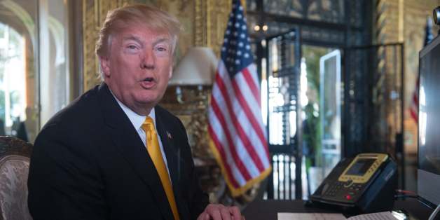 US President Donald Trump prepares his traditionnal adress to thank members of the US military via video teleconference on Thanksgiving day, November 23, 2017 from his residence in Mar-a-Lago in Florida. The US President is spending the Thanksgiving holidays in his Florida private residence until November 26. / AFP PHOTO / Nicholas KAMM (Photo credit should read NICHOLAS KAMM/AFP/Getty Images)