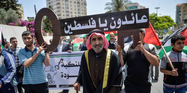 GAZA CITY, GAZA - MAY 15 : Palestinian men hold banners and keys symbolize the Palestinian settlements demolished by Israel Authority during a march marking the 69th anniversary of Nakba, also known as Day of the Catastrophe in 1948, in Gaza City, Gaza, on May 15, 2017. The march demand the rights of Palestinian people to return to their homeland. (Photo by Mustafa Hassona/Anadolu Agency/Getty Images)