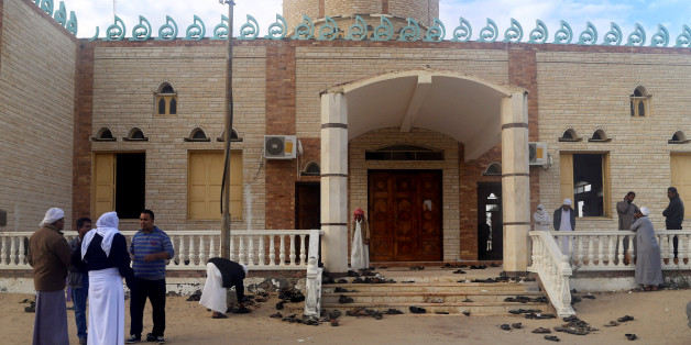 People stand outside Al Rawdah mosque, where a bomb exploded, in Bir Al-Abed, Egypt November 25, 2017. REUTERS/Mohamed Soliman