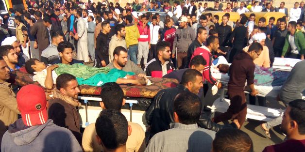 TOPSHOT - Egyptians carry victims on stretchers following a gun and bombing attack on the Rawda mosque near the North Sinai provincial capital of El-Arish on November 24, 2017.Armed attackers killed at least 235 worshippers in a bomb and gun assault on the packed mosque in Egypt's restive North Sinai province, in the country's deadliest attack in recent memory. / AFP PHOTO / - (Photo credit should read -/AFP/Getty Images)